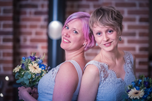 bridesmads posed wearing blue dresses