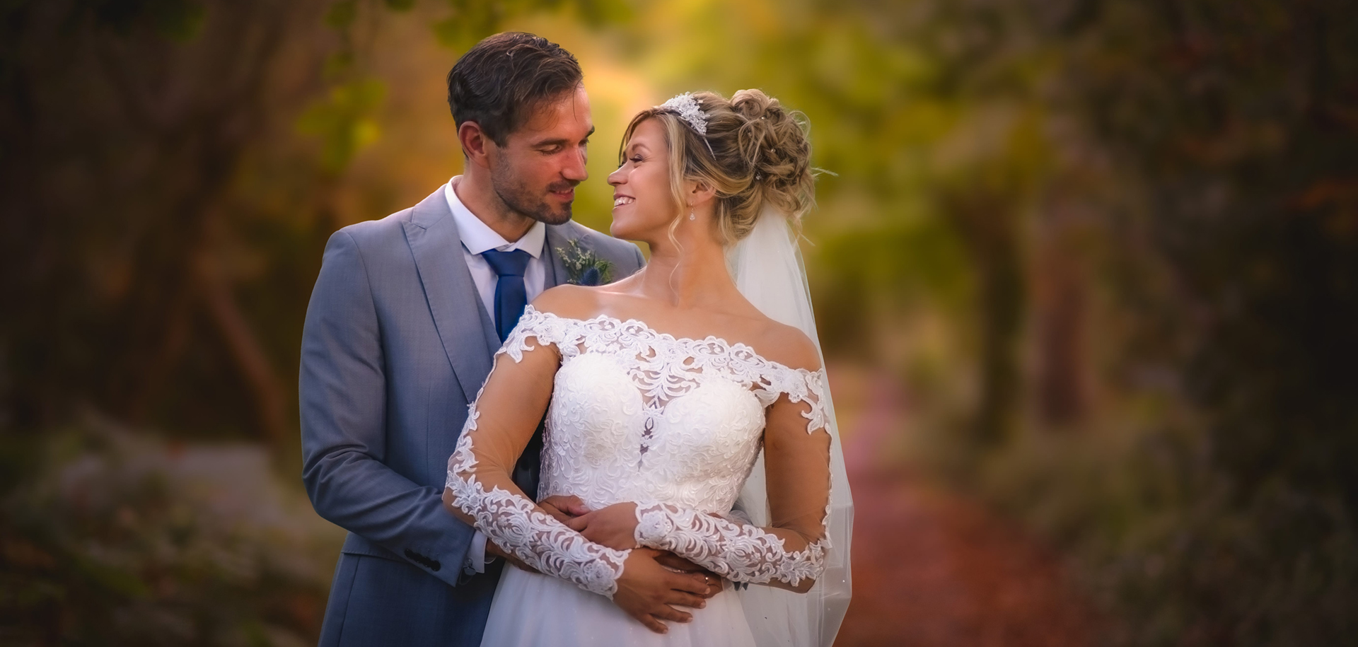 bride and groom posed on a woodland path