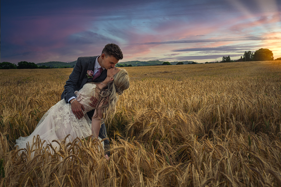 wedding couple kissing posed in a corn field