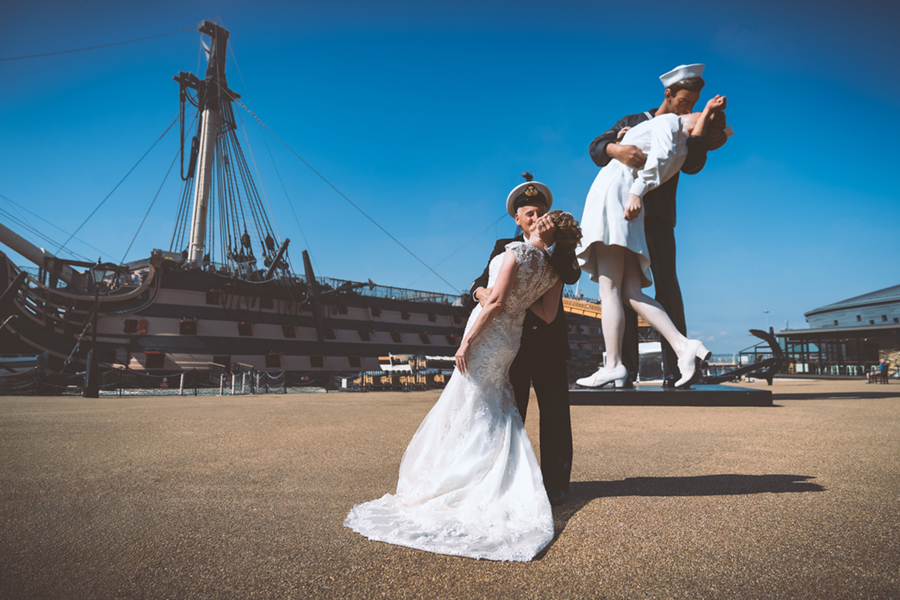 wedding couple kissing with the hms victory in the background