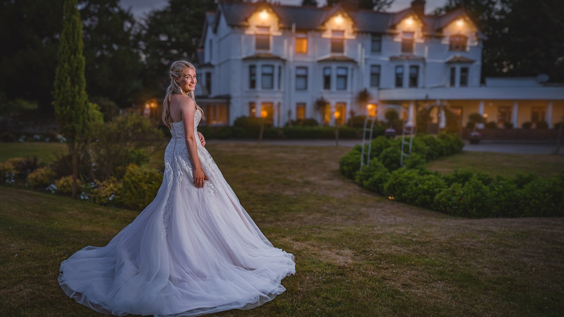 bride in her dress posed outside a southdowns manor