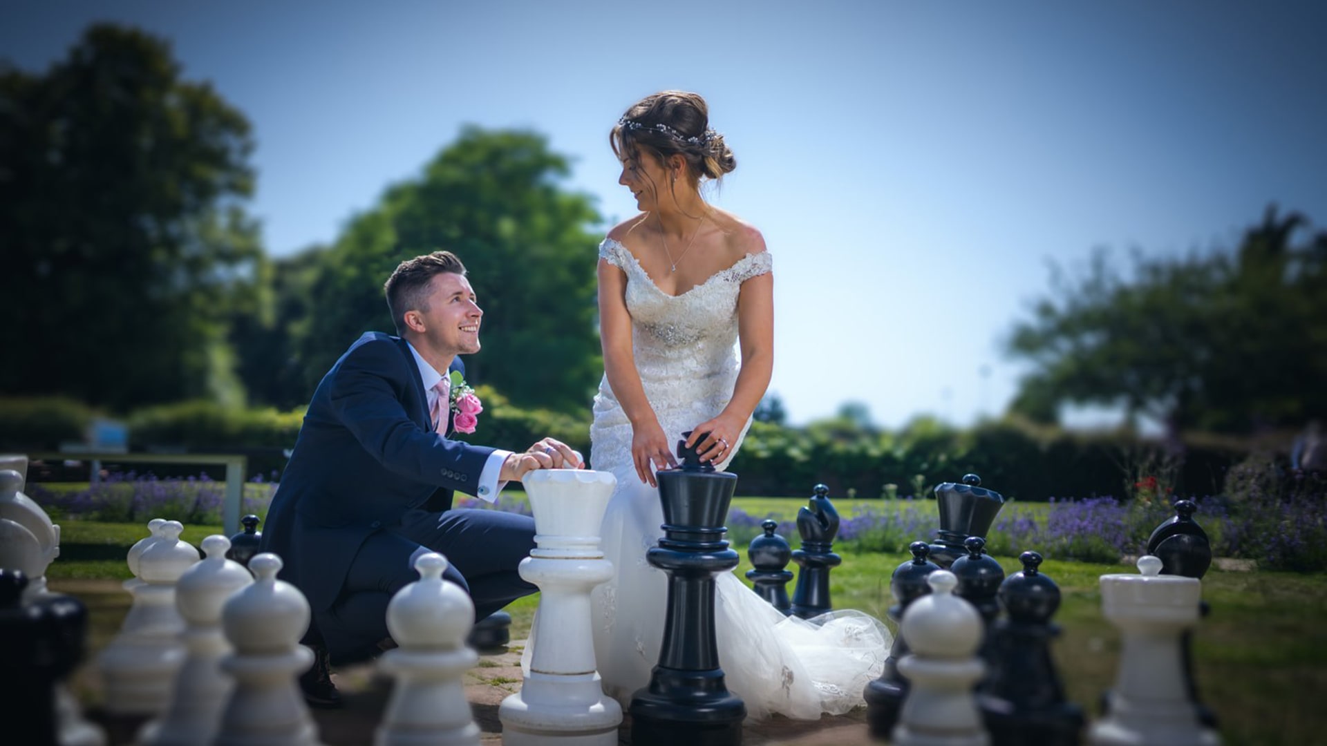 wedding couple playing giant chess at Hilton Avisford Park wedding venue