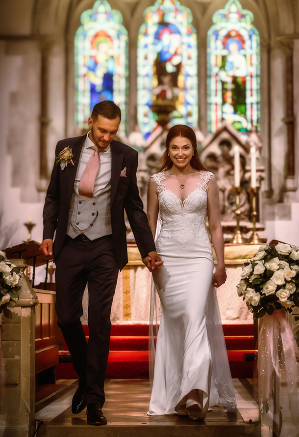 just married wedding couple walking abck down the isle