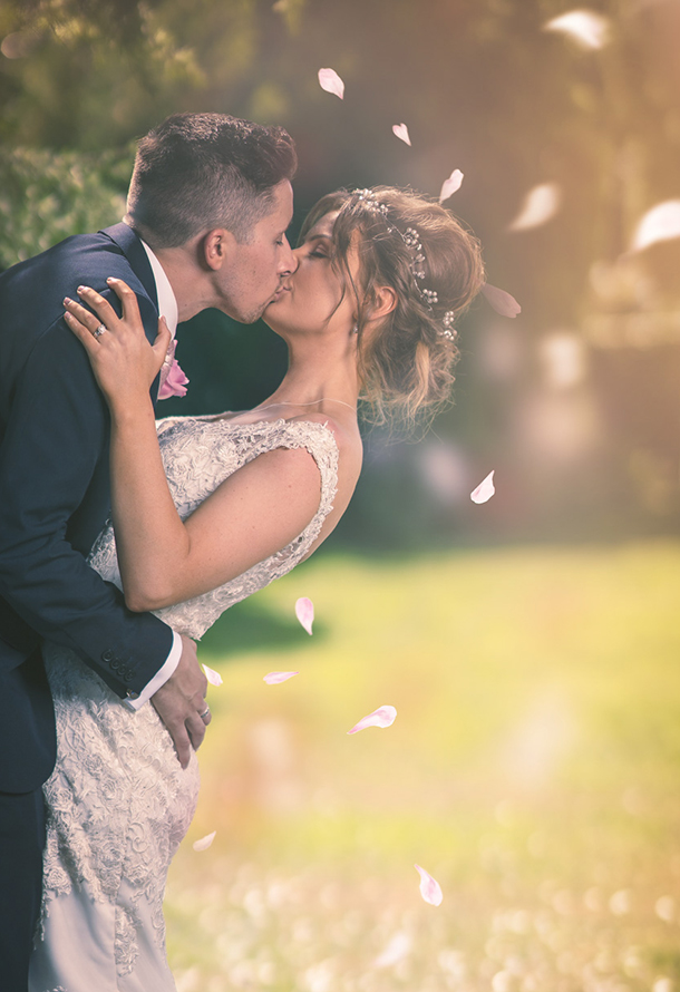 wedding couple kissing with leaves falling