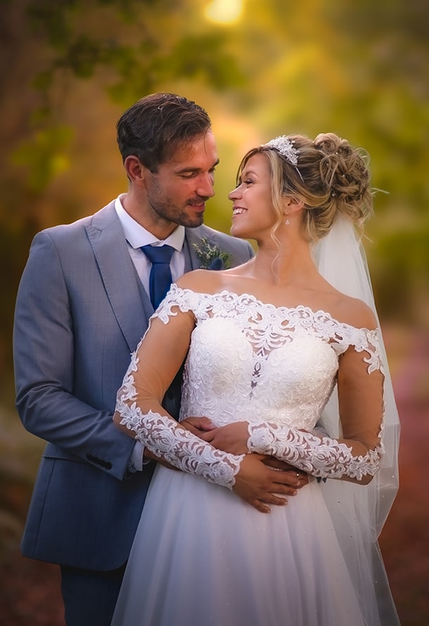 wedding couple posed on a woodland path