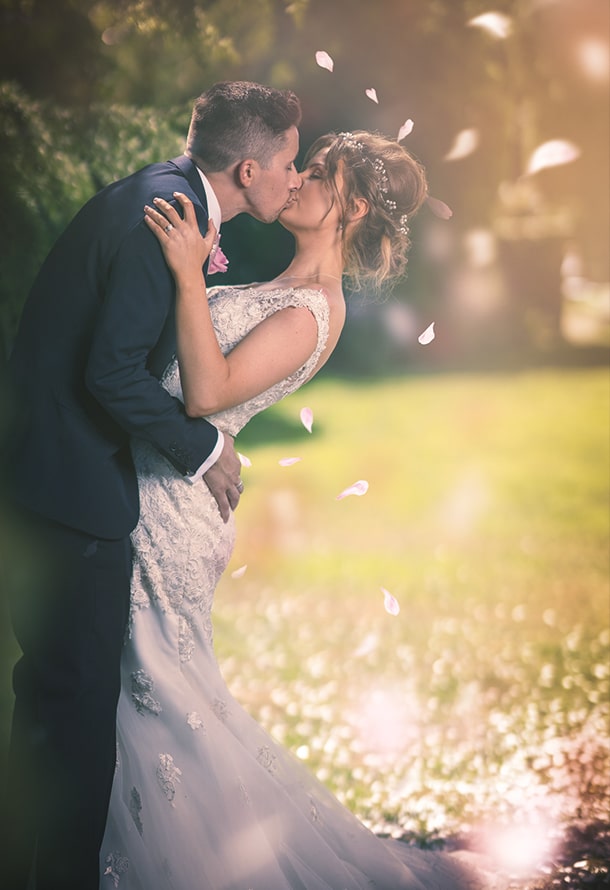 couple kissing with leaves falling