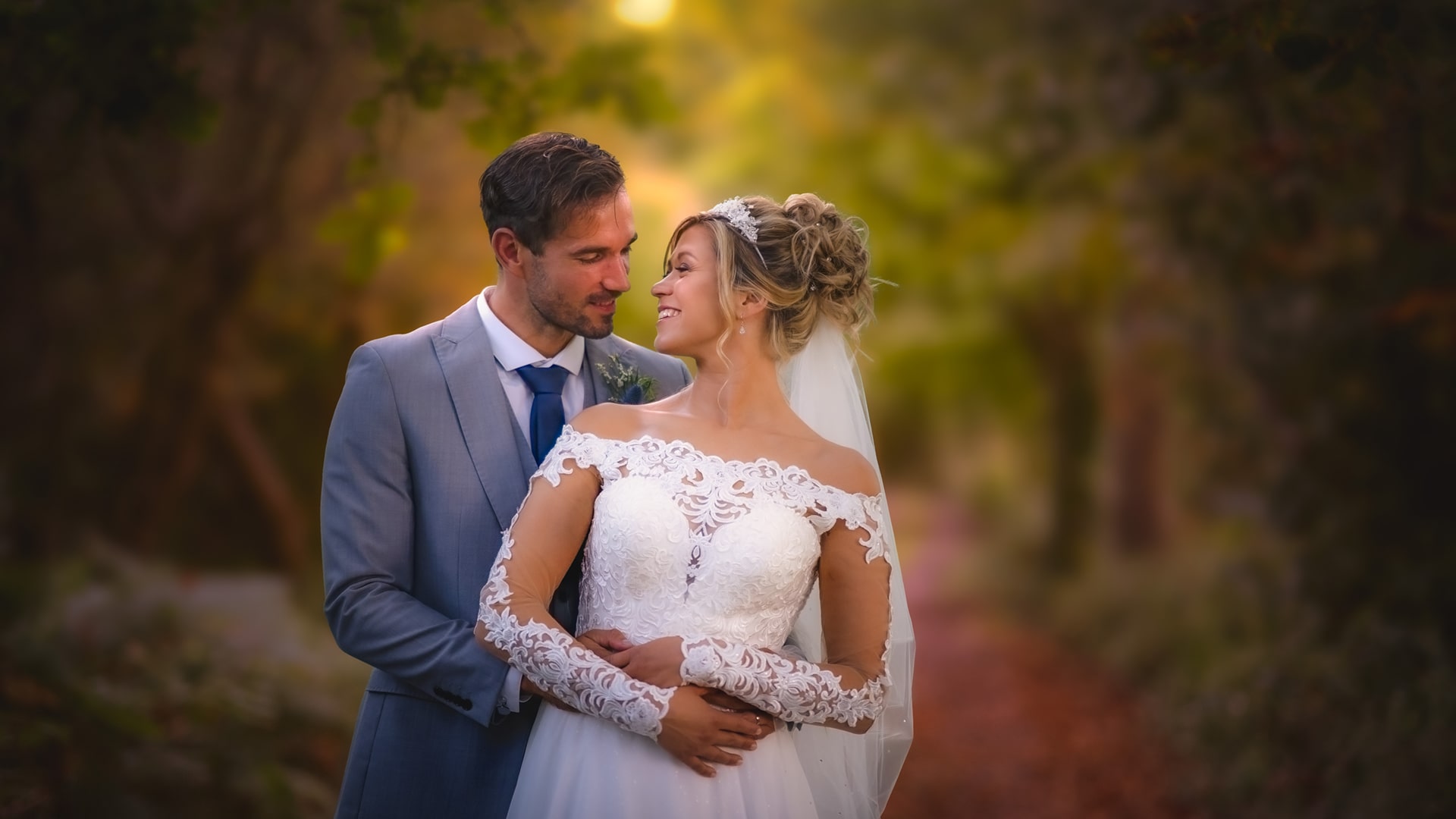 wedding couple posed on a woodland path