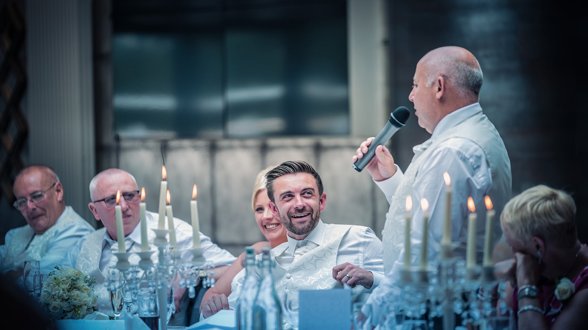 best man giving a speech with a microphone in hand