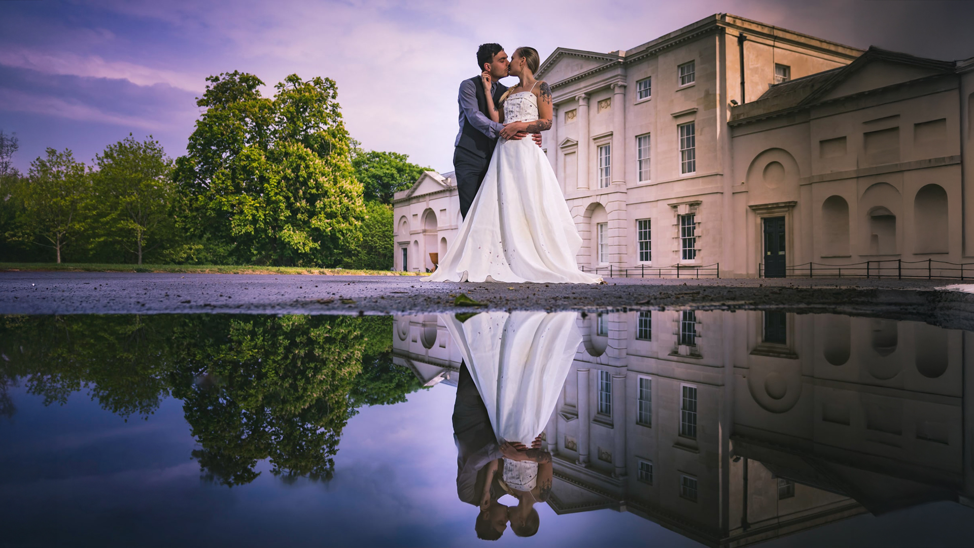 bride and groom reflected in a pool of water