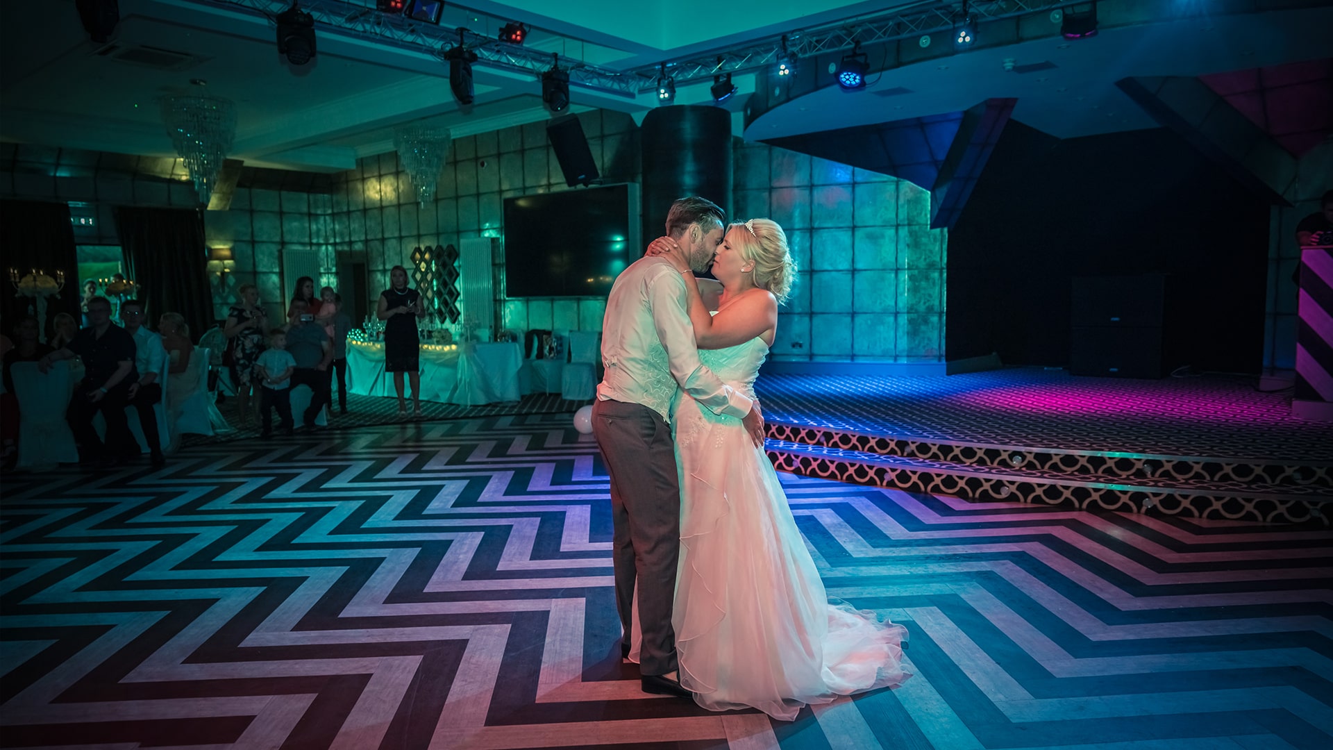 bride and groom dancing and kissing on the dance floor